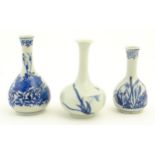 Three small Chinese blue and white bottle vases with floral and foliate decoration. One with