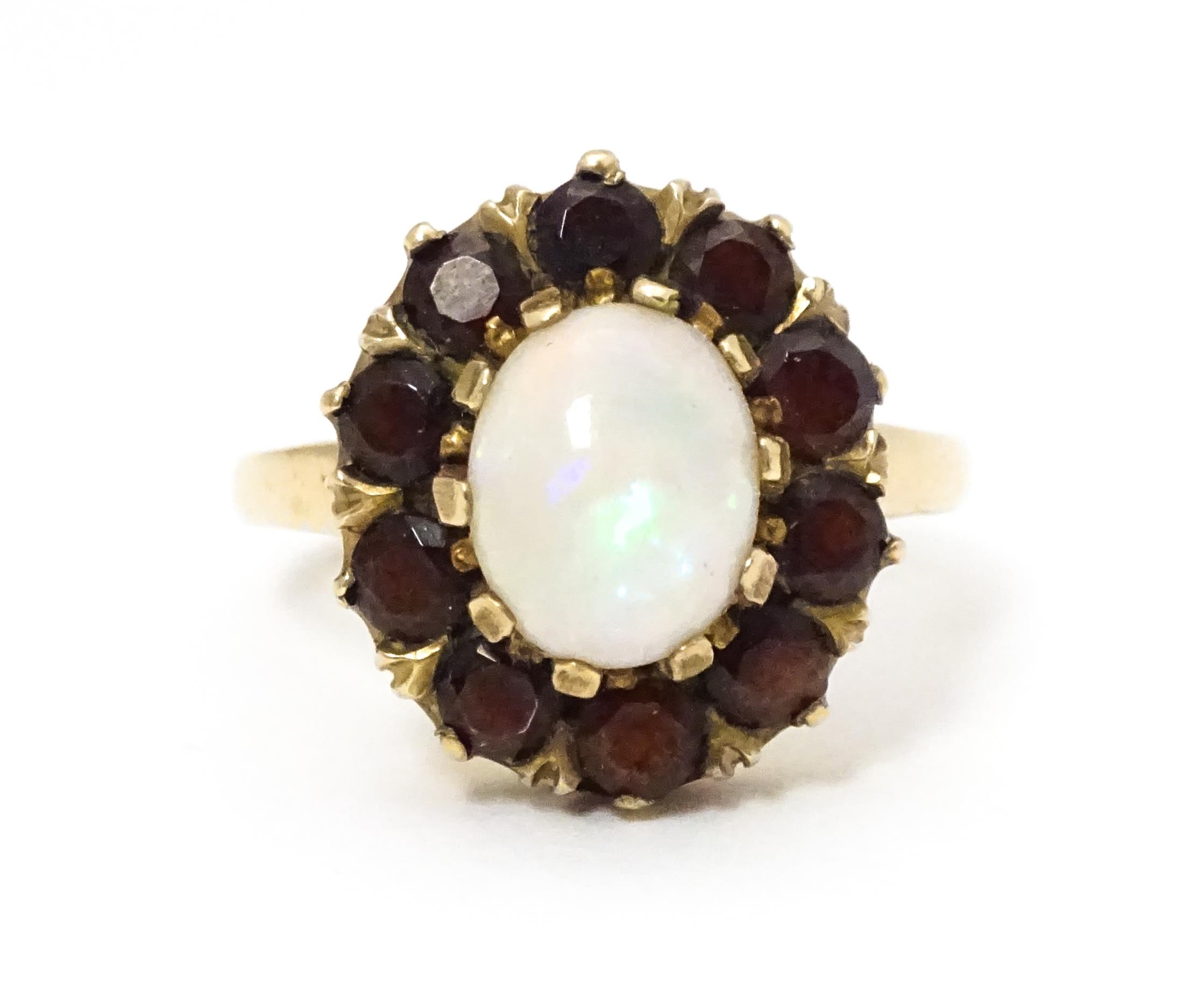 A 9ct gold ring set with central opal bordered by garnets. Ring size approx. L Please Note - we do - Image 7 of 7