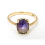 A 9ct gold ring set with oval amethyst in a claw setting. Ring size approx. P 1/2 Please Note - we