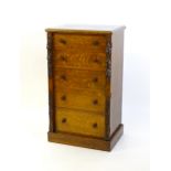 A Victorian oak Wellington chest, with a moulded top above five graduated drawers with stylised