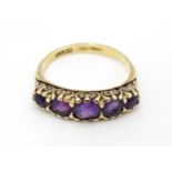 A 9ct gold ring set with 5 graduated amethysts. Ring size approx L 1/2 Please Note - we do not