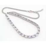 A silver necklace set amethysts. Approx 18" long Please Note - we do not make reference to the