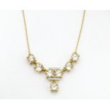 A 9ct gold necklace set with csarite and diamonds. Approx. 17" long Please Note - we do not make