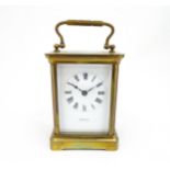 A brass carriage clock with French movement by Duverdry & Bloquel, the white enamel dial signed '