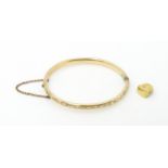 A gold plated bracelet of bangle form. Together with a gold tooth cap (2) Please Note - we do not