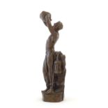 A 20thC cast sculpture after Richard Aurili, depicting a miner drinking from a water vessel, with