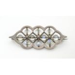 An Arts and crafts white metal brooch set with moonstone beads 1 3/4" wide Please Note - we do not