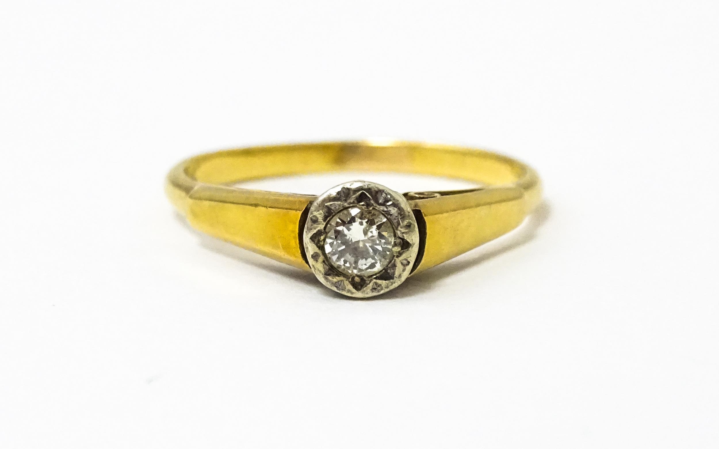 An 18ct gold ring with central illusion set diamond. Ring size approx O Please Note - we do not make