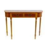 A yew wood veneered console table with a bow fronted, reeded top above two short drawers raised on