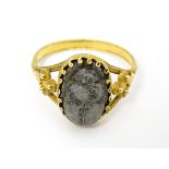 Egyptian Revival Jewellery : A Continental yellow metal ring with carved hardstone scarab beetle