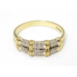 A 9ct gold ring having double band detail with six segments each set with four diamonds. Ring size