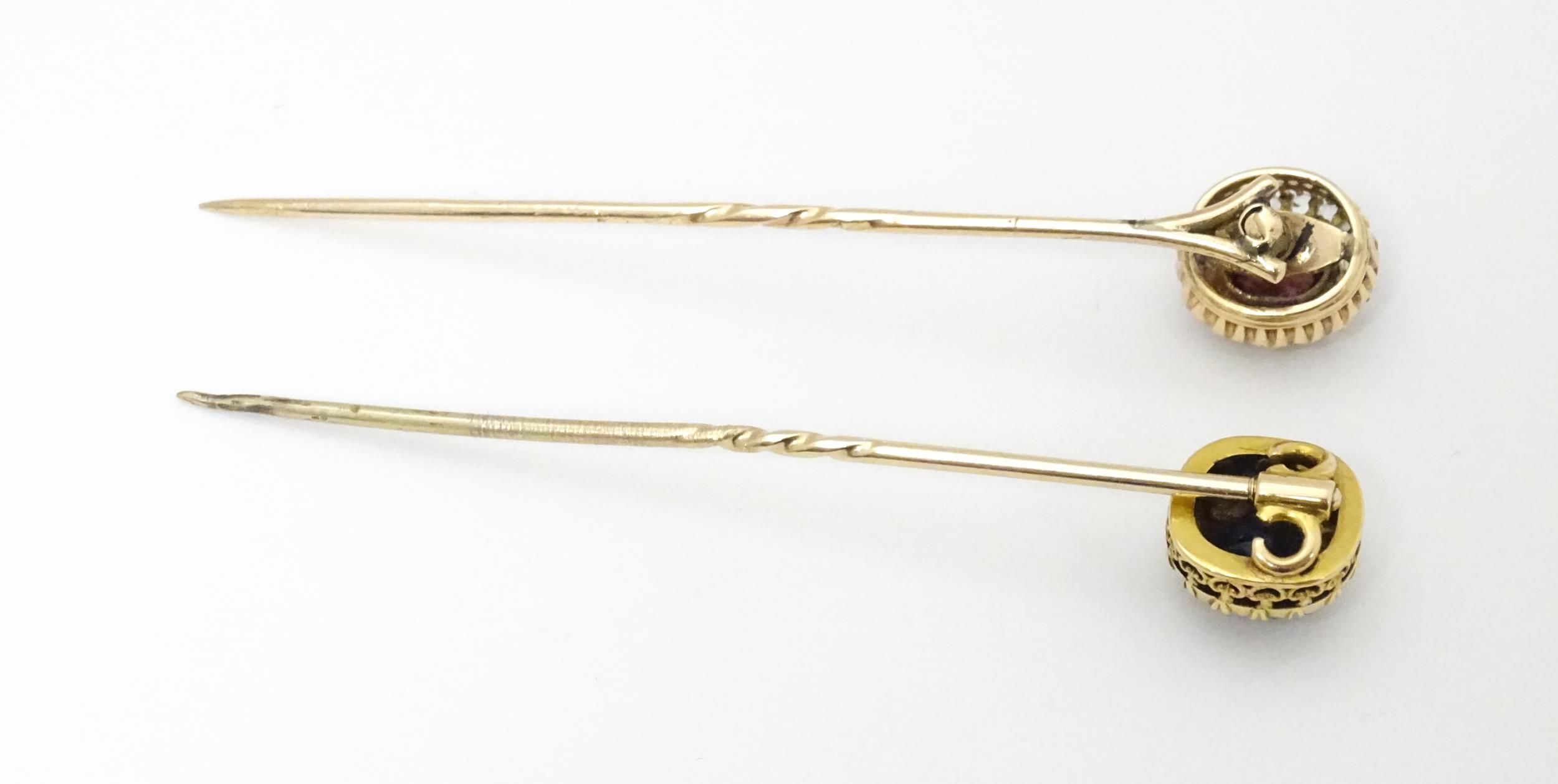 Two yellow metal stick pins, one surmounted by a central sapphire bordered by diamonds, the other - Image 3 of 6