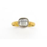A 19thC yellow metal ring set with central white stone. Ring size approx J Please Note - we do not