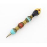 A propelling pencil with blackamoor and turquoise bead detail. Stamped Florenza. Approx. 4" long