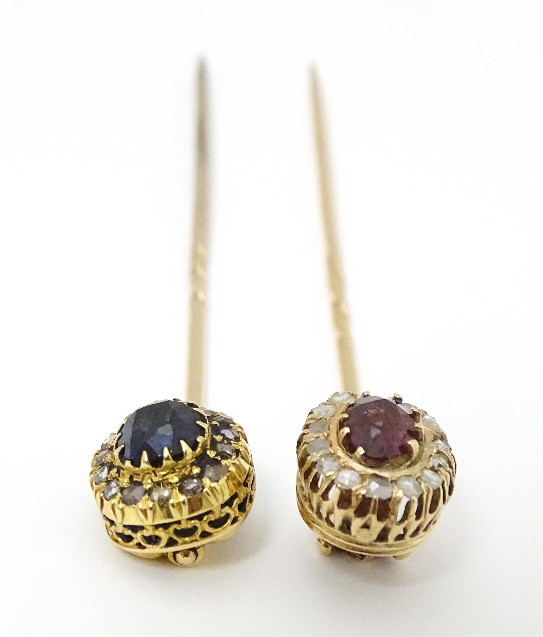 Two yellow metal stick pins, one surmounted by a central sapphire bordered by diamonds, the other - Image 5 of 6