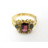 A Victorian 12ct gold ring set with garnet and pearl hallmarked Birmingham 1857. Maker J.A Ring size