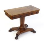 A 19thC mahogany card table with a rectangular top above applied, carved roundel decoration with a