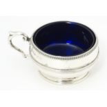 A silver salt with blue glass liner hallmarked Birmingham 1919 maker Collingwood & Sons Ltd.