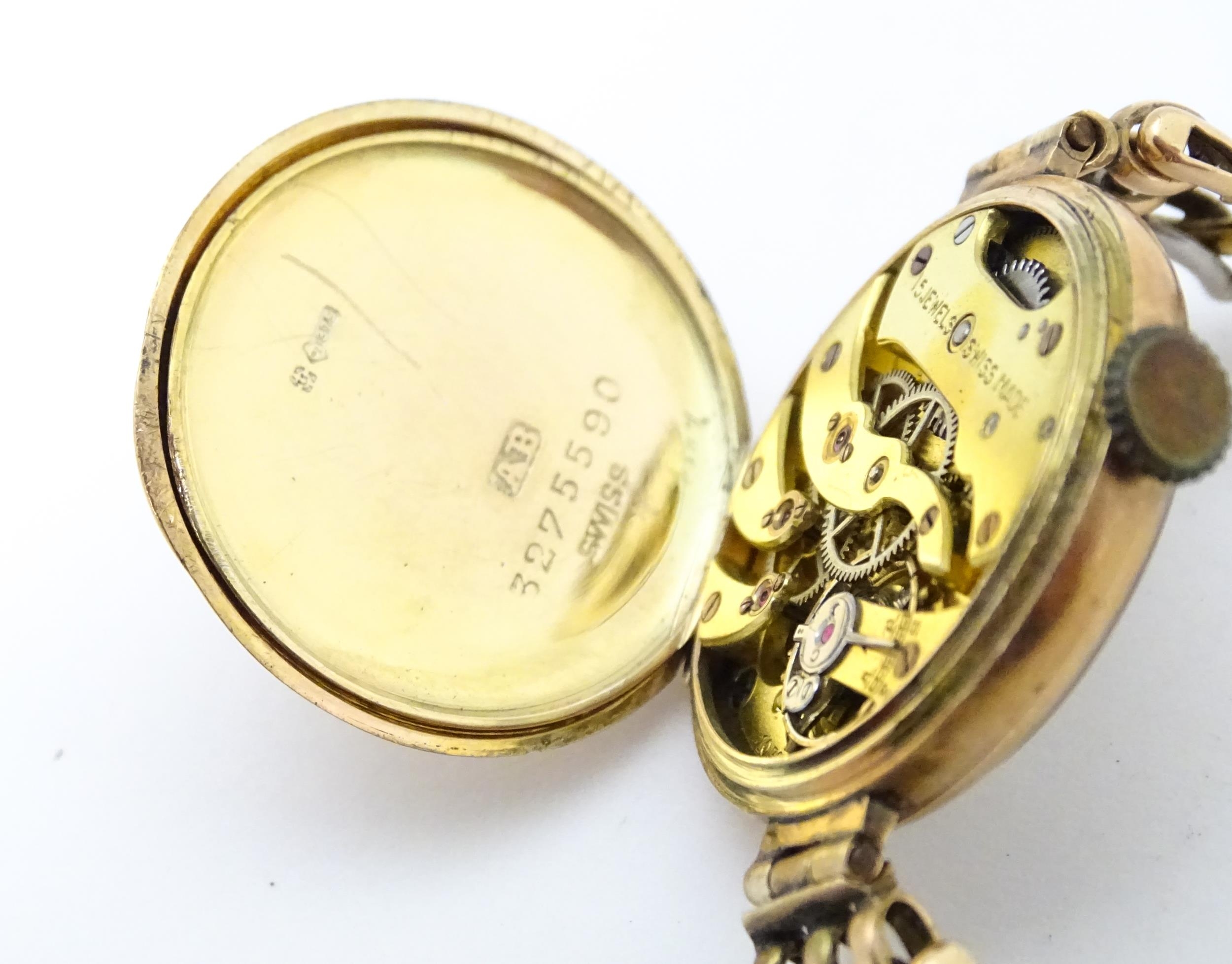 A c.1925 9ct gold cast ladies wristwatch, the dial with engraved decoration, Arabic numerals and - Image 10 of 11