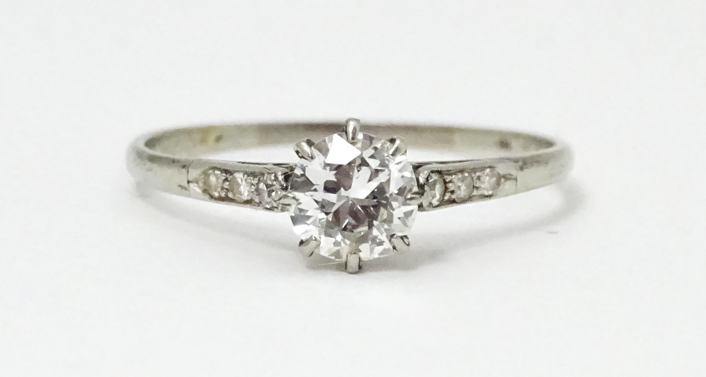 A 18ct white gold ring set with diamond solitaire ring flanked by 3 diamonds to the shoulders. - Image 7 of 7