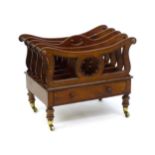 A mid 19thC mahogany Canterbury with a pierced handle, four sections with bowed top rails and