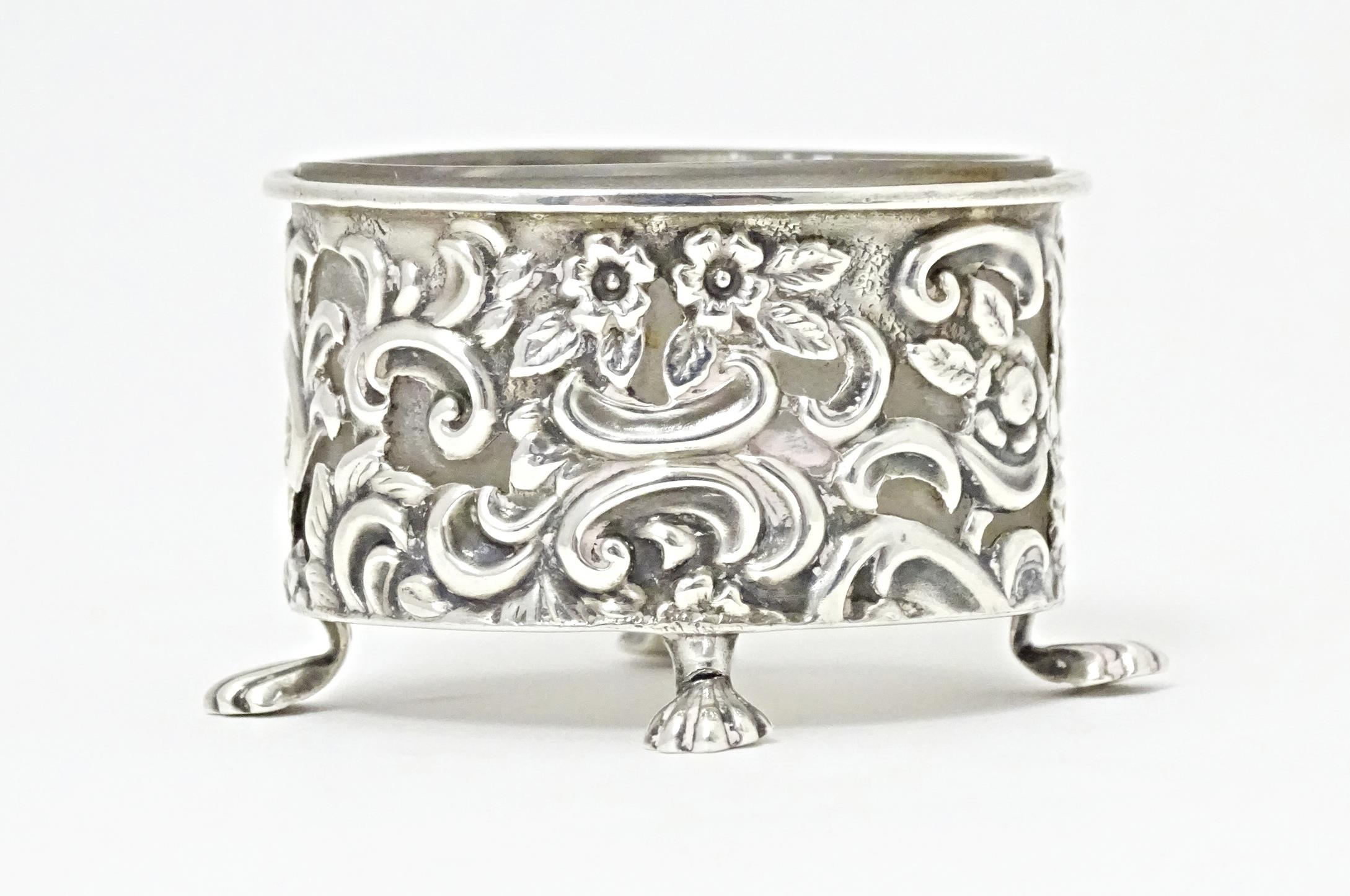 A Victorian silver salt of oval form with embossed decoration and four stylised paw feet, and - Image 6 of 7