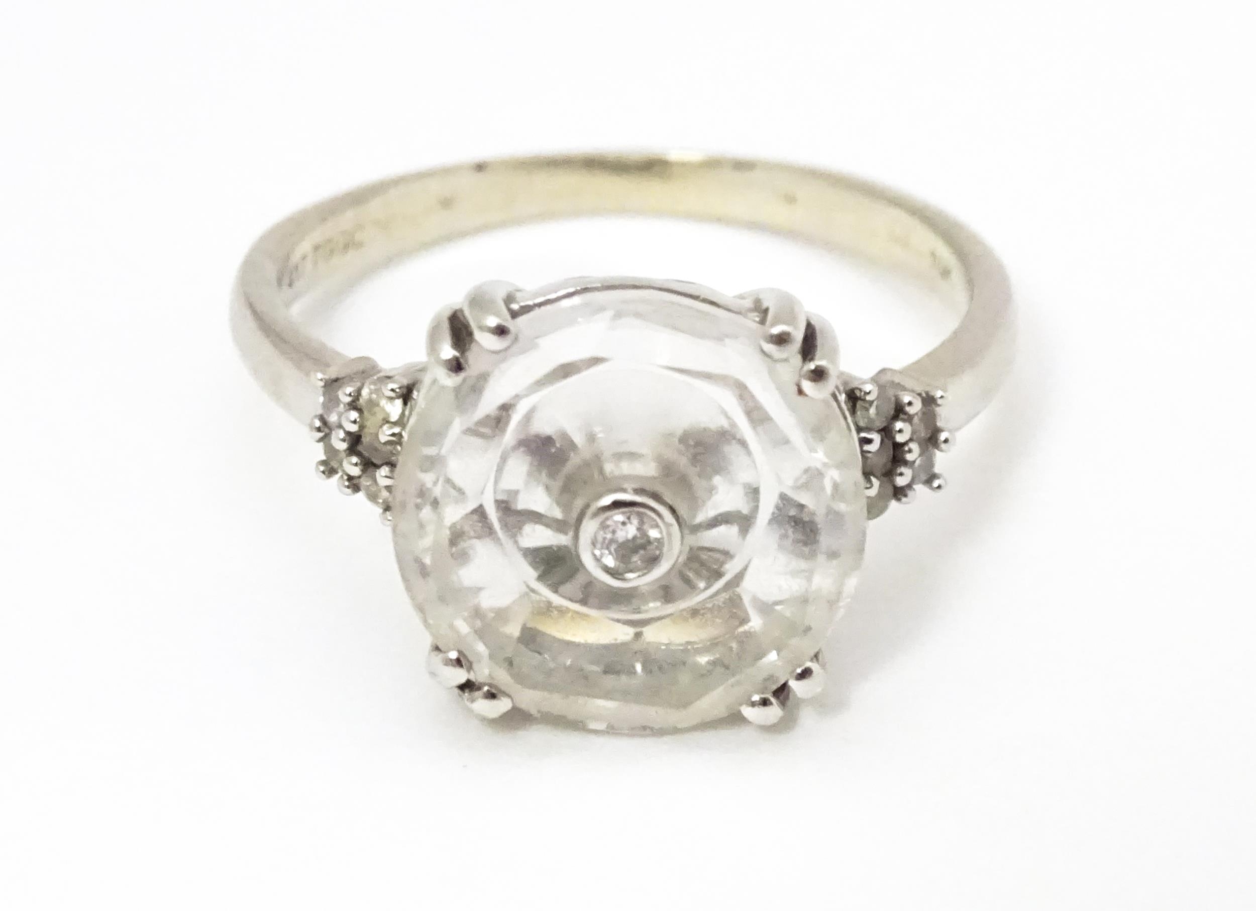 A 10k white gold Lehrer Torus ring set with Bahia quartz and central diamond. Ring size approx M