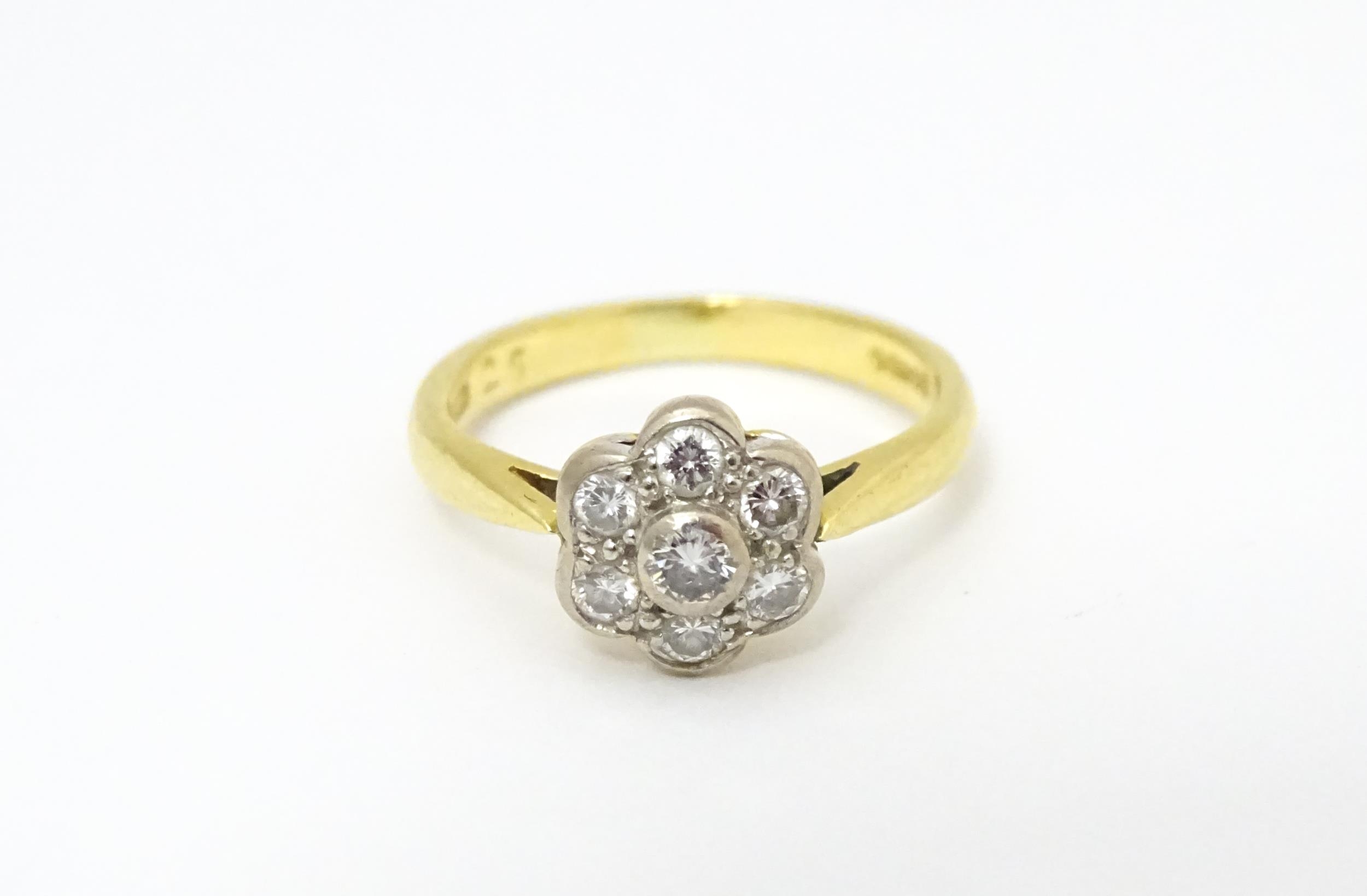 An 18ct gold ring set with 7 diamonds in a daisy setting. Ring size approx. H Please Note - we do - Image 3 of 10