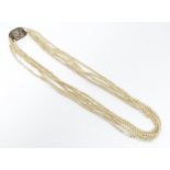 A five strand pearl necklace with a 9ct gold clasp marked W. T. P. Approx. 14" long Please Note - we