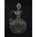 A 19thC etched glass water jug / carafe and stopper with floral fuchsia detail. Approx. 8" high