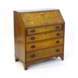 An 18thC oak bureau with a crossbanded fall front containing a fitted interior with small drawers,