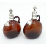 Two 19thC amber glass flasks / decanters with silver plate mounts. Largest approx 9" high (2) Please