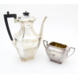 A silver coffee / hot water pot hallmarked Sheffield 1910 together with a twin handled sugar