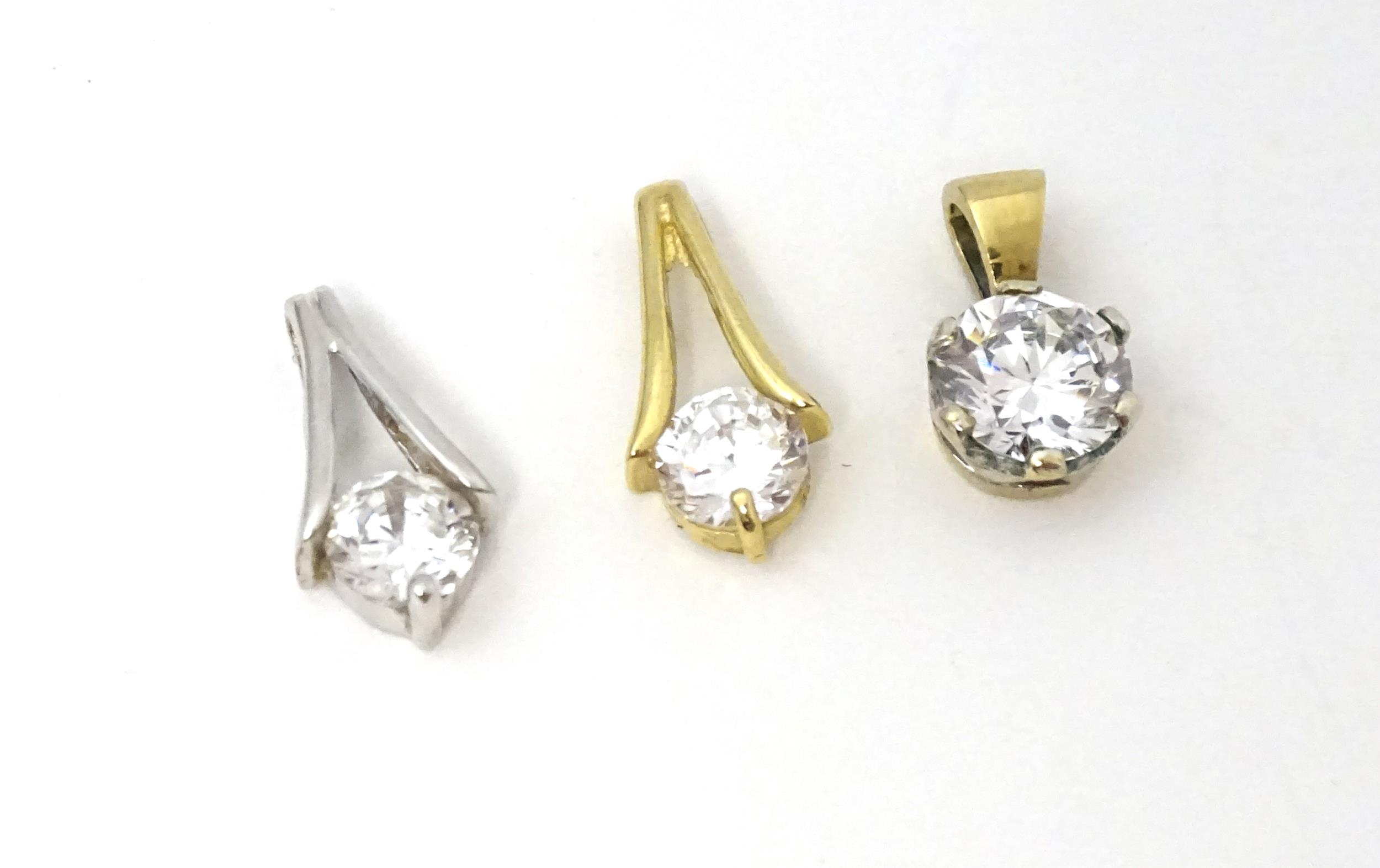 Three 9ct gold pendants set with cubic zirconia. To include a white gold example. Approx 1/2"