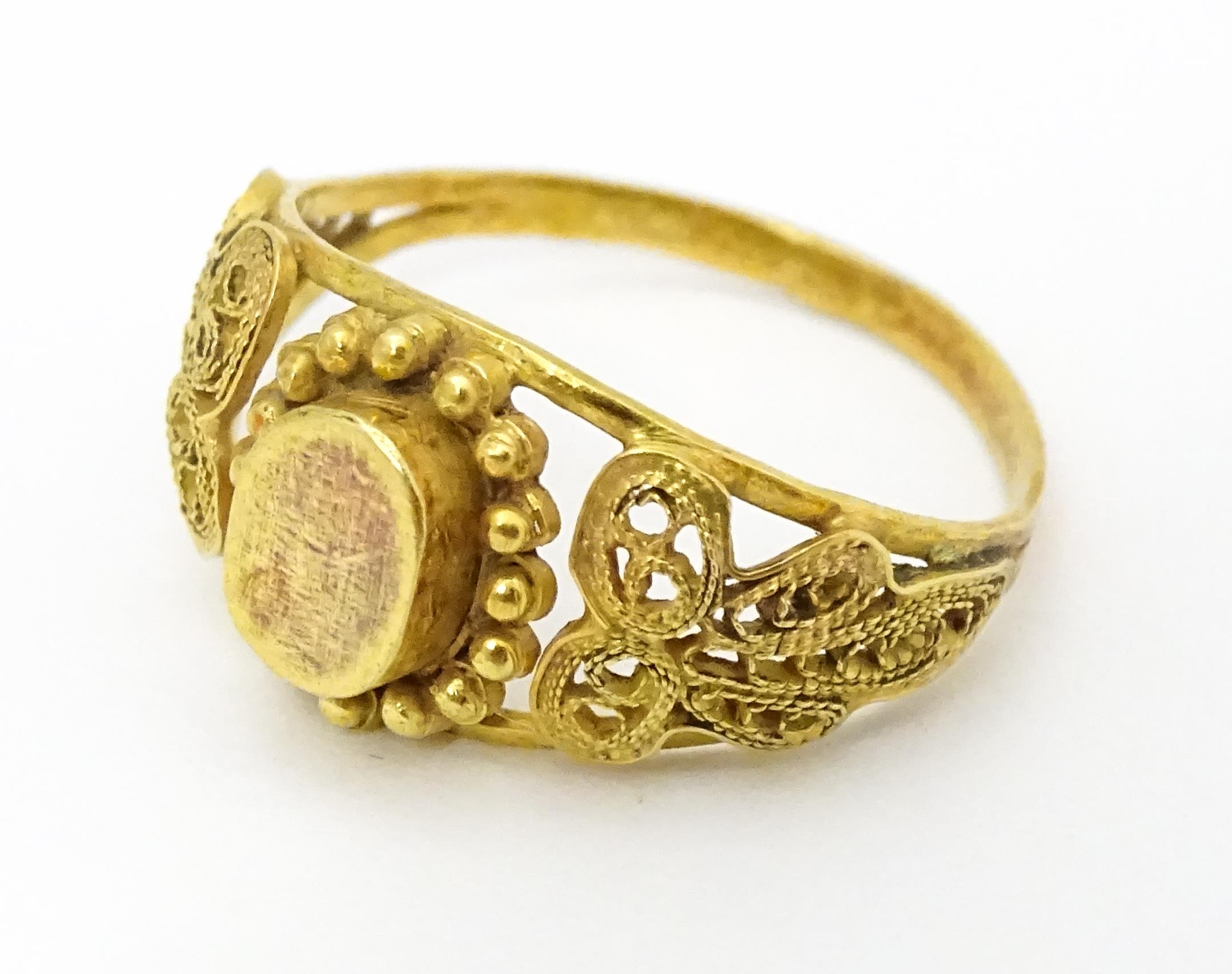 A yellow metal ring with filigree decoration. Ring size approx. K 1/2 Please Note - we do not make - Image 2 of 7