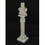 An early 20thC carved composite marble table lamp of squared pillar form, with twin horse detail.