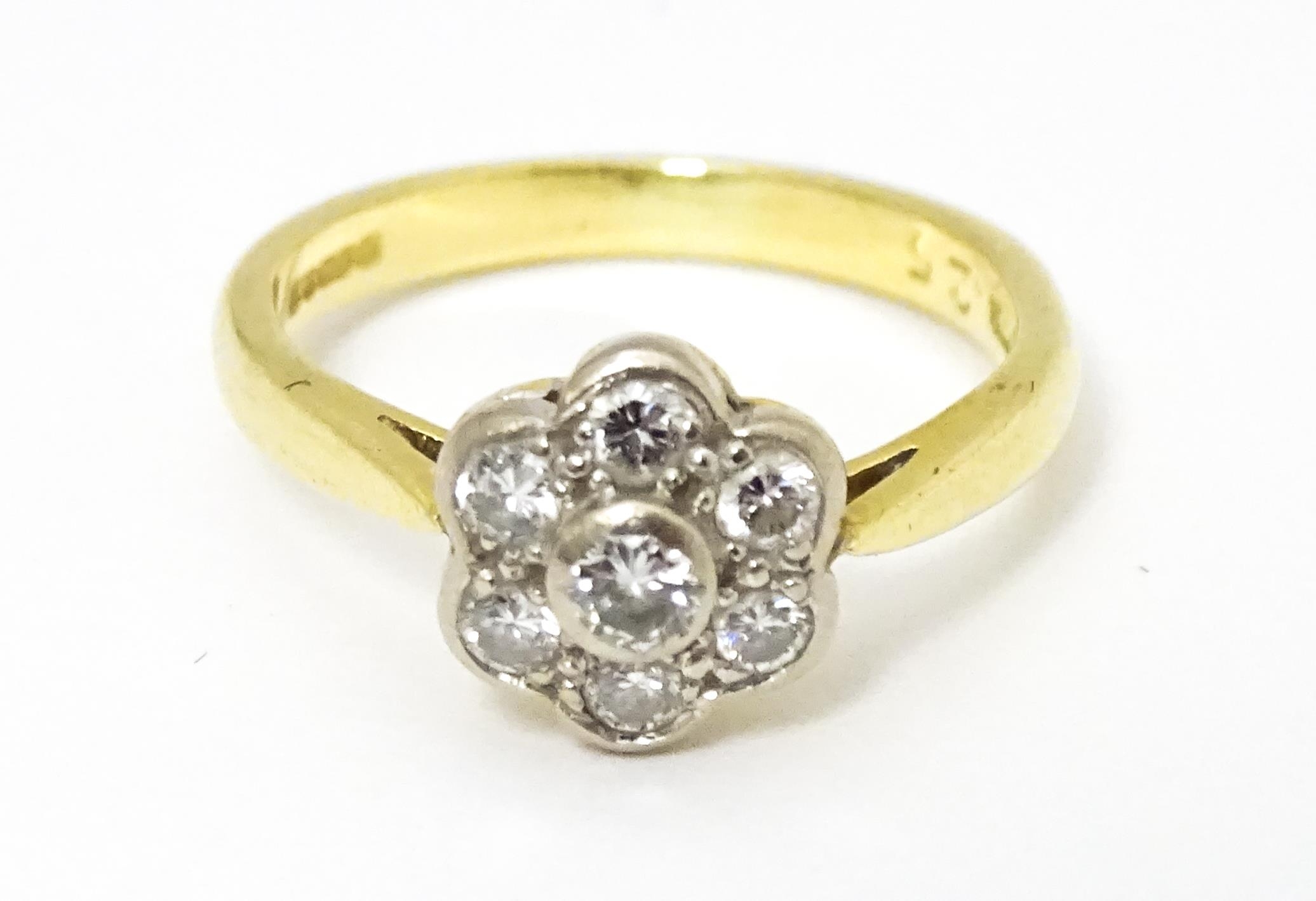 An 18ct gold ring set with 7 diamonds in a daisy setting. Ring size approx. H Please Note - we do - Image 5 of 10