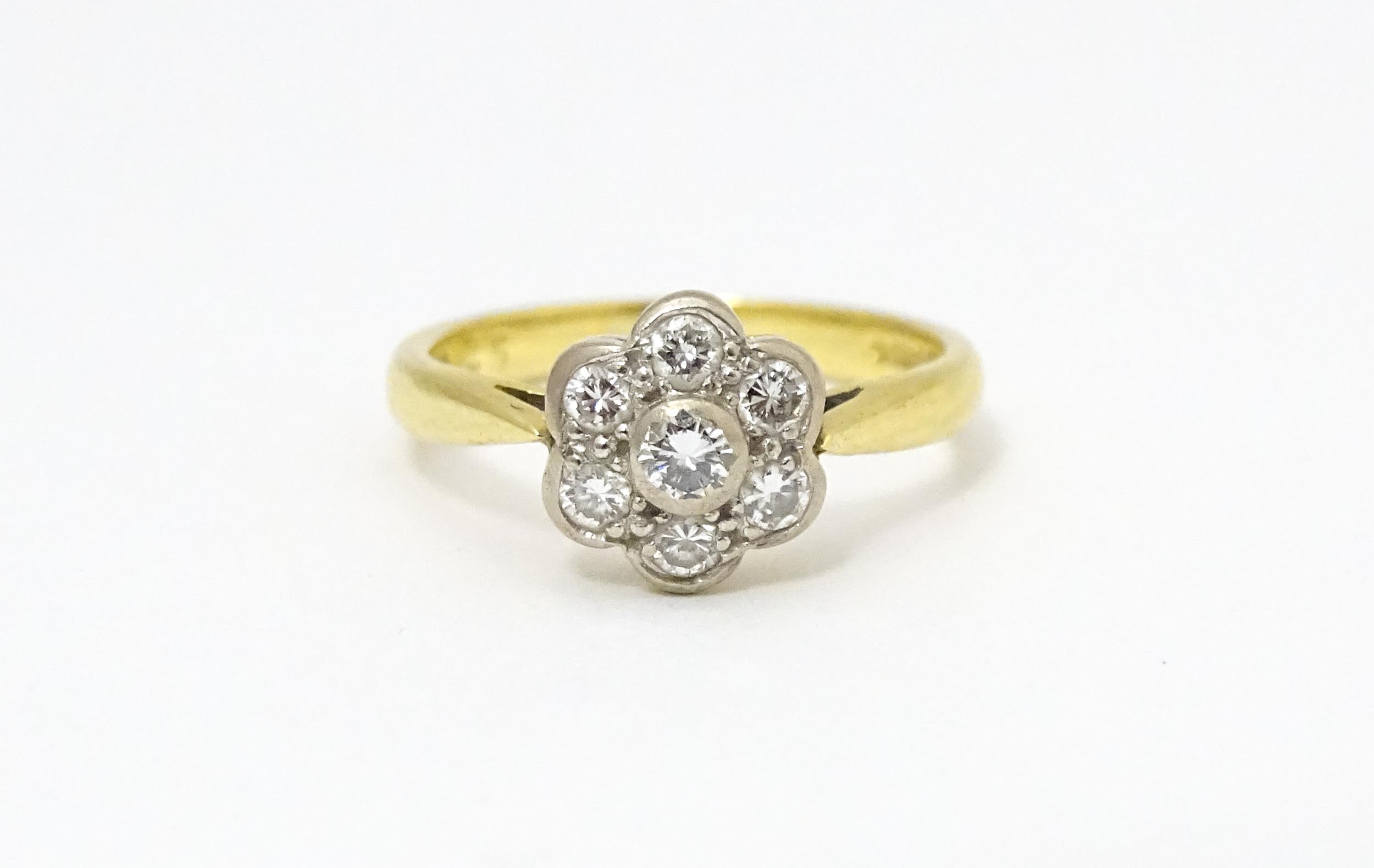 An 18ct gold ring set with 7 diamonds in a daisy setting. Ring size approx. H Please Note - we do - Image 2 of 10