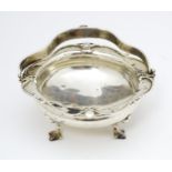 A silver bonbon dish with swing handle hallmarked London 1919 maker E.A.D and stamped Watherston