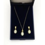 A suite of miniature cameo jewellery, comprising earrings and a pendant on a 9ct gold chain.