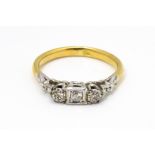 A gold ring set with trio of diamonds. Ring size approx. H 1/2 Please Note - we do not make