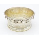 A silver bowl with fruiting vine decoration and twin handles with rams head decoration. Hallmarked