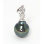 A 9ct white gold pendant set with Maruata pearl and cubic zirconia. Approx. 1 1/2" long Please