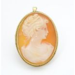 A 9ct gold pendant / brooch set with a shell carved cameo. Approx 1 1/2" long Please Note - we do