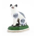 A Chelsea style model of a seated cat. Gold anchor mark under. Approx. 2 1/2" high Please Note -