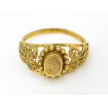 A yellow metal ring with filigree decoration. Ring size approx. K 1/2 Please Note - we do not make