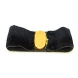 A yellow metal and velvet ribbon cuff. Indistinctly marked and stamped GZ. The oval clasp approx.