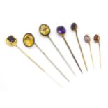 Seven assorted gold / yellow metal / gilt metal stick pins to include a 9ct gold example set with