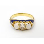 A 19thC yellow gold ring set with central diamond flanked by opals in a blue enamel setting. Ring