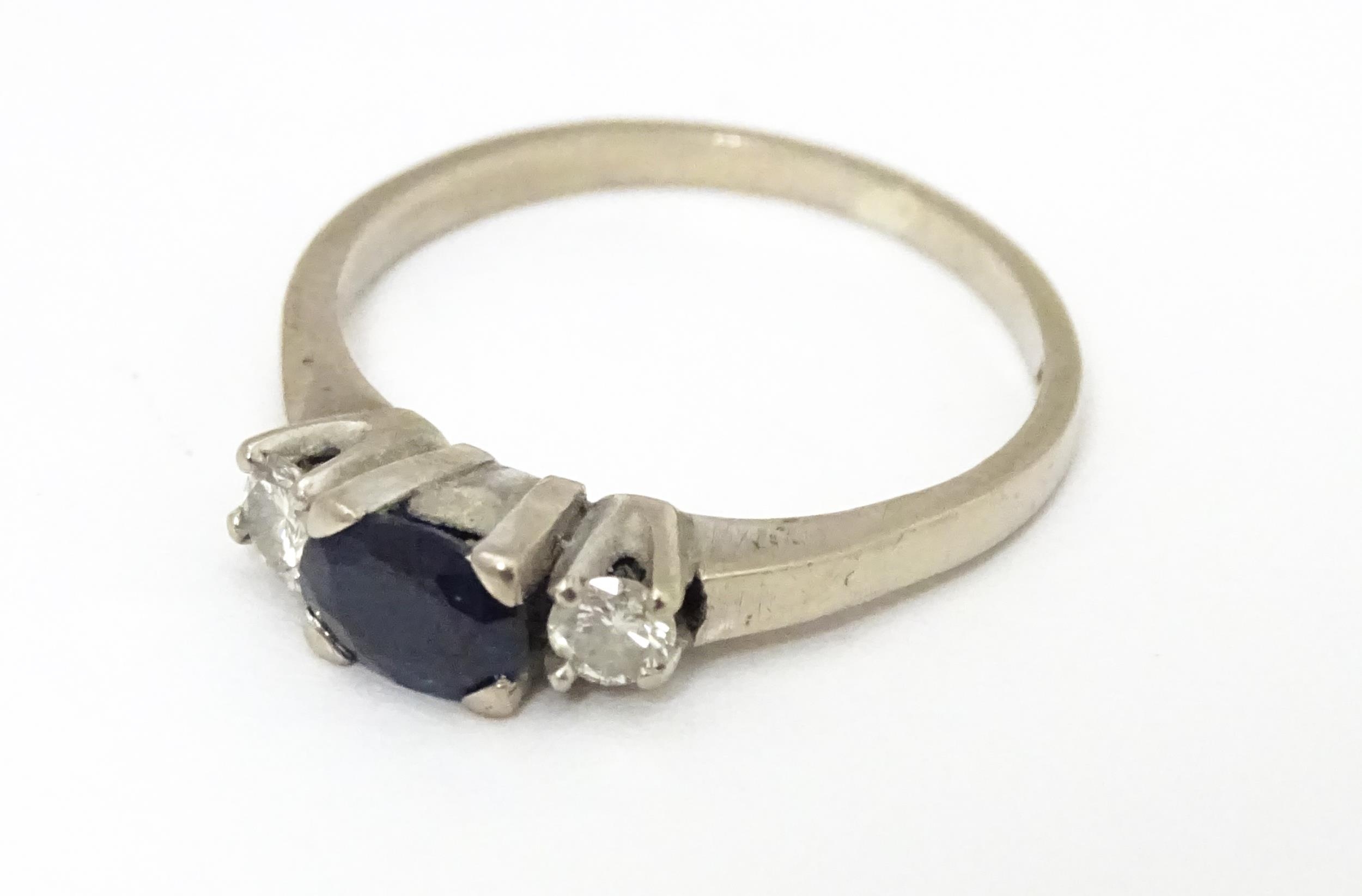 An 18ct white gold ring set with central sapphire flanked by diamonds. Ring size approx. M 1/2 - Image 3 of 6